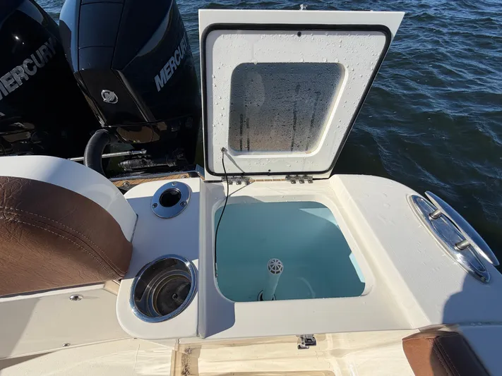  Yacht Photos Pics 2026 Scout 277 LXF boat with open storage compartment and engines.