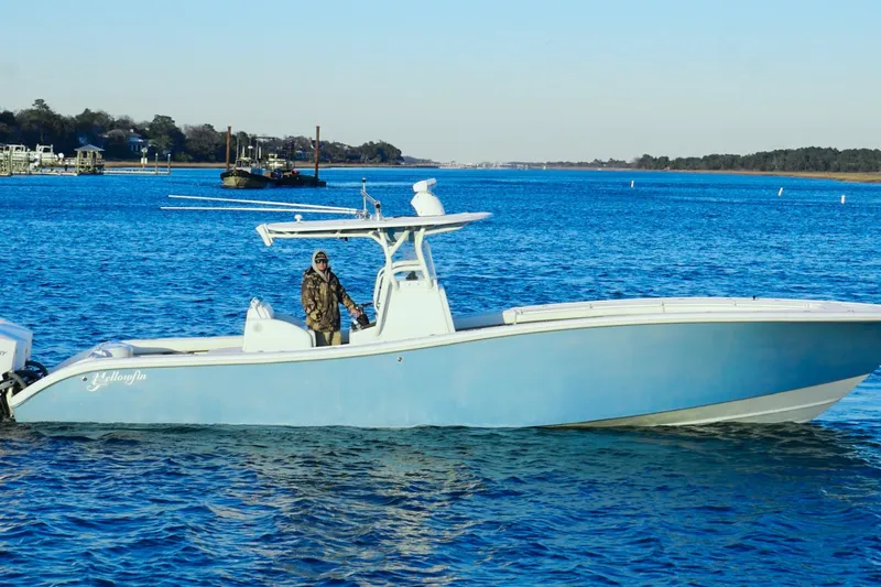  Yacht Photos Pics 2007 Yellowfin 36 Offshore boat on blue water, with a person onboard.