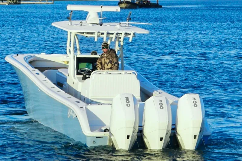  Yacht Photos Pics 2007 Yellowfin 36 Offshore boat with triple engines on blue water.