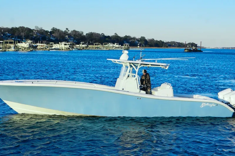 Yacht Photos Pics 2007 Yellowfin 36 Offshore boat cruising on a serene blue waterway.