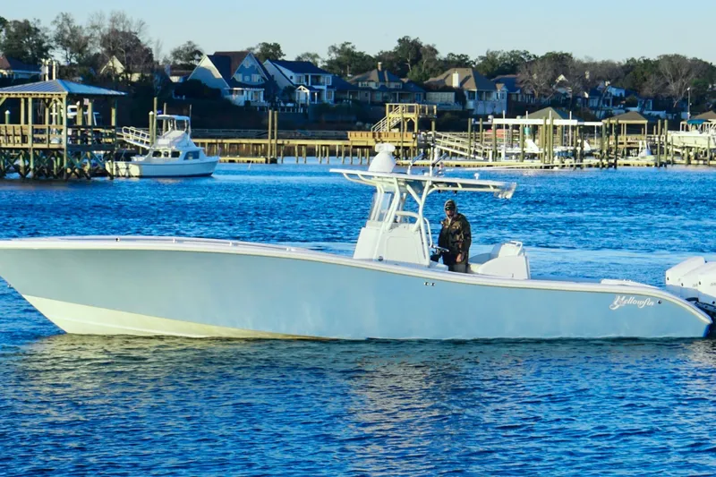 Yacht Photos Pics 2007 Yellowfin 36 Offshore boat on calm water near docks and houses.
