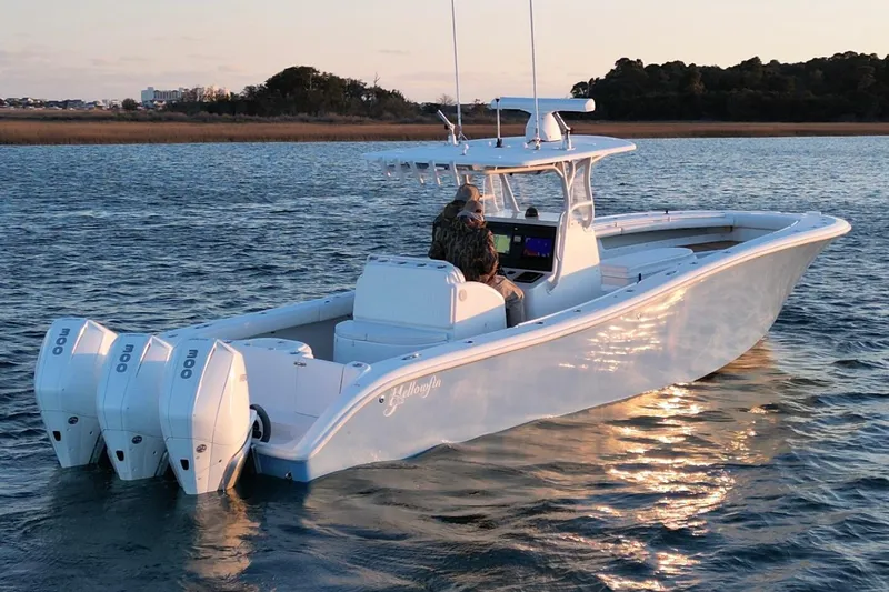  Yacht Photos Pics 2007 Yellowfin 36 Offshore boat on calm water at sunset.