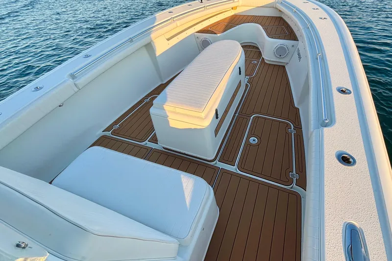  Yacht Photos Pics 2007 Yellowfin 36 Offshore boat interior with teak flooring and cushioned seating.