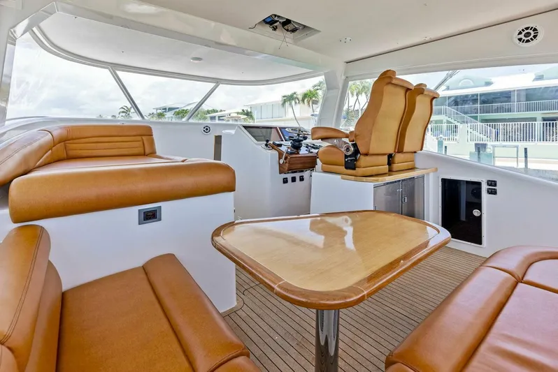  Yacht Photos Pics Interior of 2020 Calcutta 480 Catamaran with tan leather seating and wooden table.