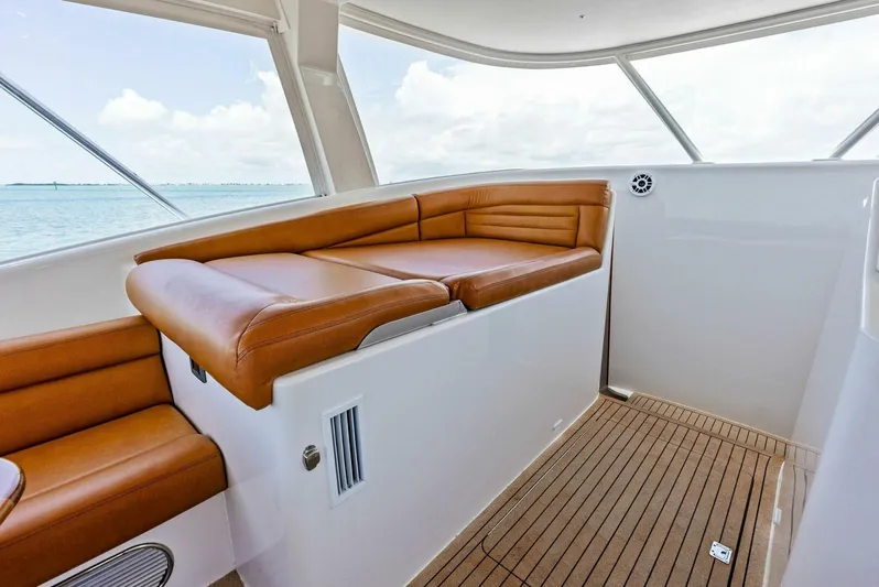  Yacht Photos Pics Interior seating area of 2020 Calcutta 480 Catamaran with brown leather cushions.