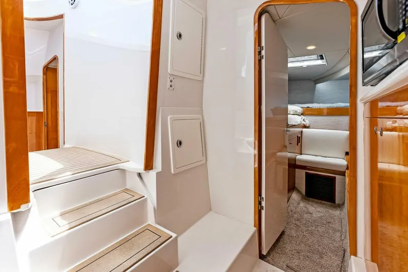  Yacht Photos Pics Interior of 2020 Calcutta 480 Catamaran with stairs, cabin, and wooden finishes.