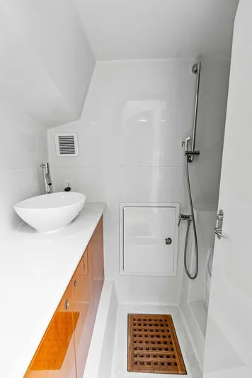  Yacht Photos Pics Modern bathroom in 2020 Calcutta 480 Catamaran with sleek fixtures and wooden shower mat.