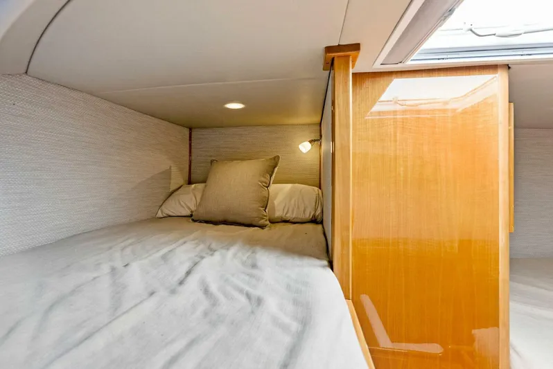  Yacht Photos Pics Cozy sleeping quarters in 2020 Calcutta 480 Catamaran with soft lighting and wooden accents.