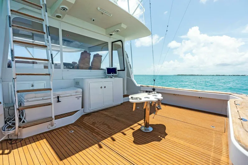  Yacht Photos Pics 2020 Calcutta 480 Catamaran deck with ocean view, wooden flooring, and fishing setup.