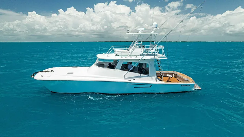  Yacht Photos Pics 2020 Calcutta 480 Catamaran cruising on clear blue ocean waters.