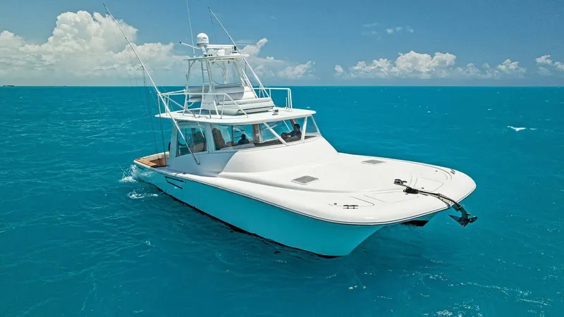  Yacht Photos Pics 2020 Calcutta 480 Catamaran cruising on clear blue ocean waters.