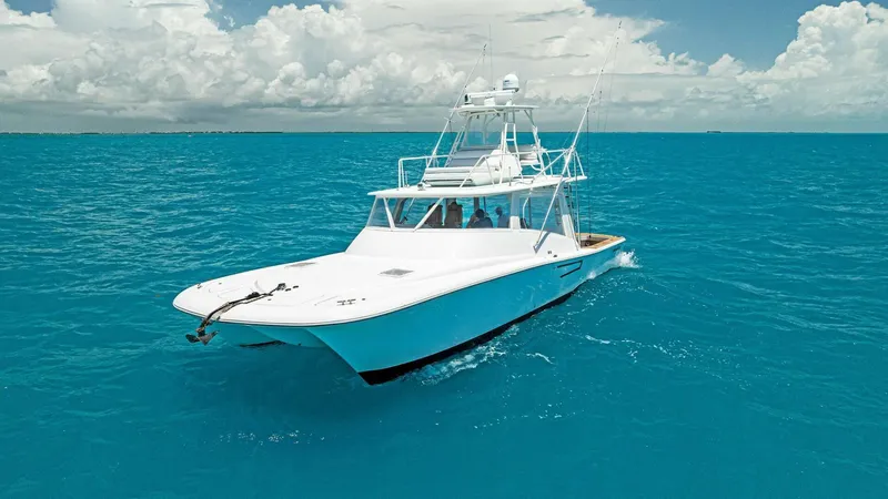  Yacht Photos Pics 2020 Calcutta 480 Catamaran cruising on clear blue ocean waters.