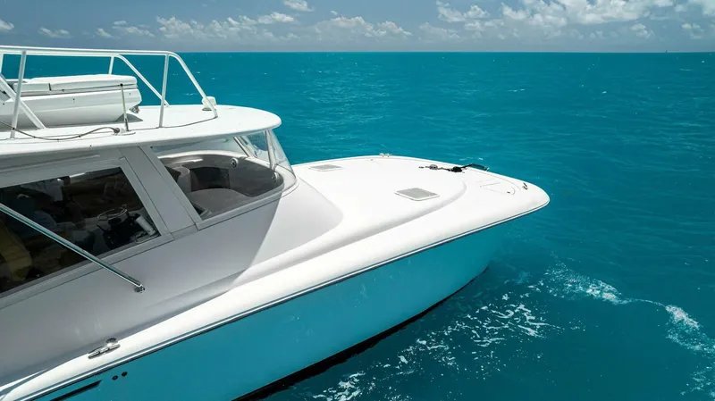  Yacht Photos Pics 2020 Calcutta 480 Catamaran cruising on clear blue ocean waters.