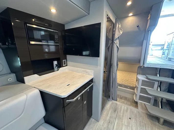  Yacht Photos Pics Interior of 2021 Formula 400 Super Sport Crossover with modern kitchen and cozy sleeping area.