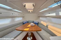Luxurious interior of 2023 Intrepid 41 Valor yacht with elegant seating and wooden table.