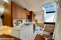 Luxurious interior of 2023 Intrepid 41 Valor yacht with modern kitchen and cozy seating area.