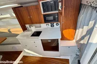 2023 Intrepid 41 Valor yacht interior with modern kitchen and wooden cabinetry.