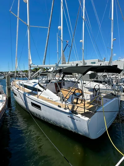 Hard Loaded Yacht Photos Pics 2024 Elan Impression 43 sailboat docked in marina under clear blue sky.