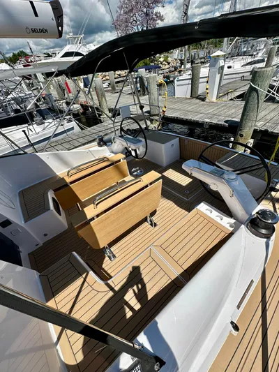 Hard Loaded Yacht Photos Pics 2024 Elan Impression 43 yacht cockpit with wooden deck and dual steering wheels.