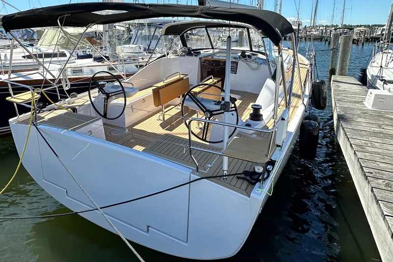 Hard Loaded Yacht Photos Pics 2024 Elan Impression 43 sailboat docked at marina, featuring spacious cockpit and dual steering wheels.