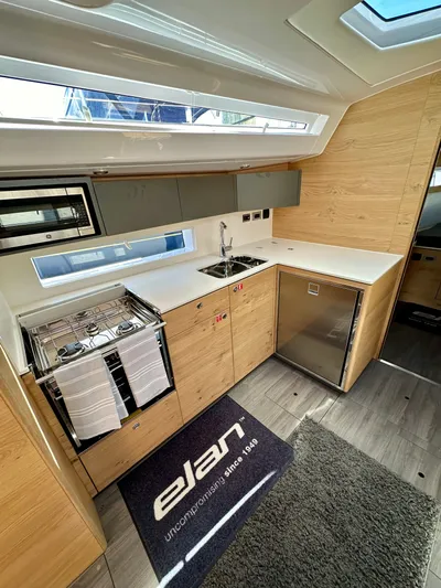 Hard Loaded Yacht Photos Pics Modern kitchen interior of 2024 Elan Impression 43 yacht with sleek design and appliances.