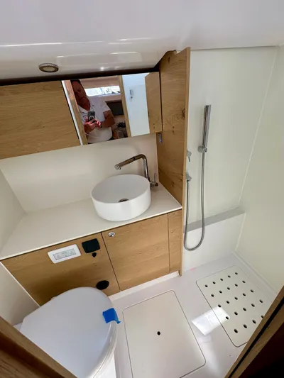 Hard Loaded Yacht Photos Pics Modern bathroom in 2024 Elan Impression 43 yacht with sleek fixtures and wooden cabinetry.