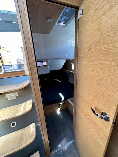 Hard Loaded Yacht Photos Pics Interior of 2024 Elan Impression 43 yacht, featuring modern wood finishes and cozy cabin space.