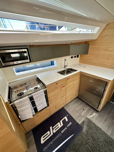 Hard Loaded Yacht Photos Pics Modern kitchen in 2024 Elan Impression 43 yacht with sleek appliances and wood finish.