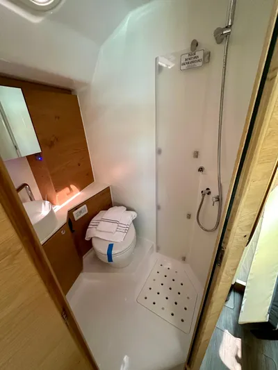 Hard Loaded Yacht Photos Pics 2024 Elan Impression 43 yacht bathroom with shower, sink, and toilet.