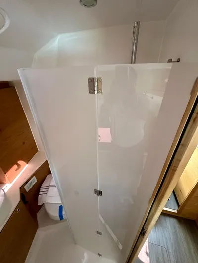 Hard Loaded Yacht Photos Pics 2024 Elan Impression 43 yacht bathroom with modern shower and wooden accents.