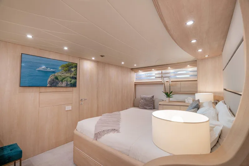 Gemini 3 Yacht Photos Pics Luxurious bedroom interior of 2002 Maiora 24S yacht with modern decor and ambient lighting.