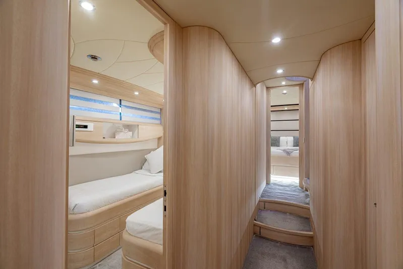 Gemini 3 Yacht Photos Pics Luxurious interior of 2002 Maiora 24S yacht with modern wood paneling and cozy cabins.