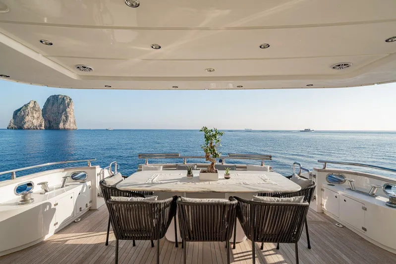 Gemini 3 Yacht Photos Pics Luxury yacht Maiora 24S, 2002 model, with elegant deck dining area and ocean view.