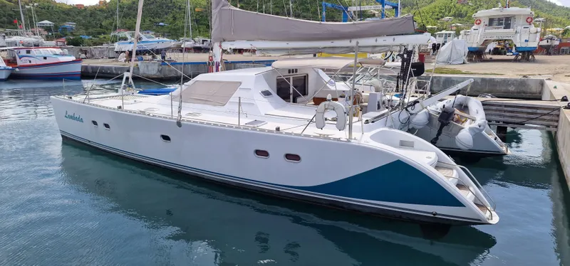 Lambada Yacht Photos Pics 1993 Lagoon 47 catamaran docked in a marina, featuring sleek design and modern amenities.