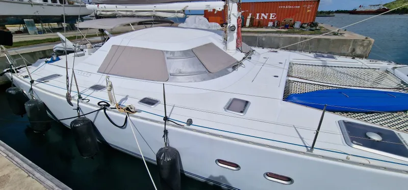 Lambada Yacht Photos Pics Lagoon 47 catamaran, 1993 model, docked at marina with visible netting and fenders.