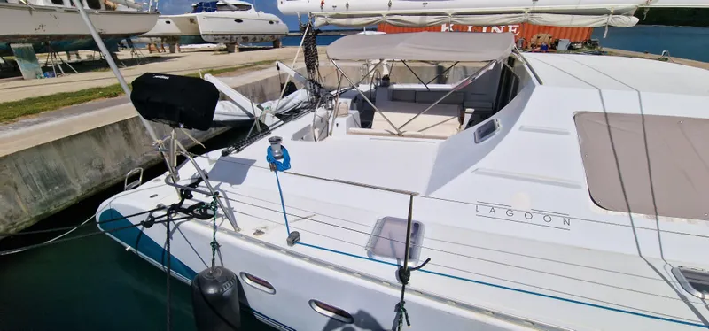 Lambada Yacht Photos Pics Lagoon 47 catamaran from 1993 docked at a marina, featuring spacious deck and seating area.