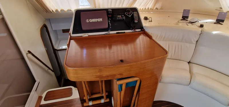 Lambada Yacht Photos Pics Interior of 1993 Lagoon 47 yacht with navigation equipment and white seating.