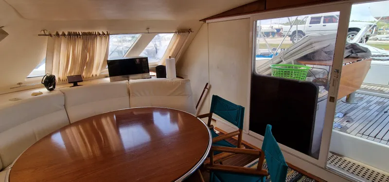 Lambada Yacht Photos Pics Interior of 1993 Lagoon 47 yacht with round table and sliding glass door.