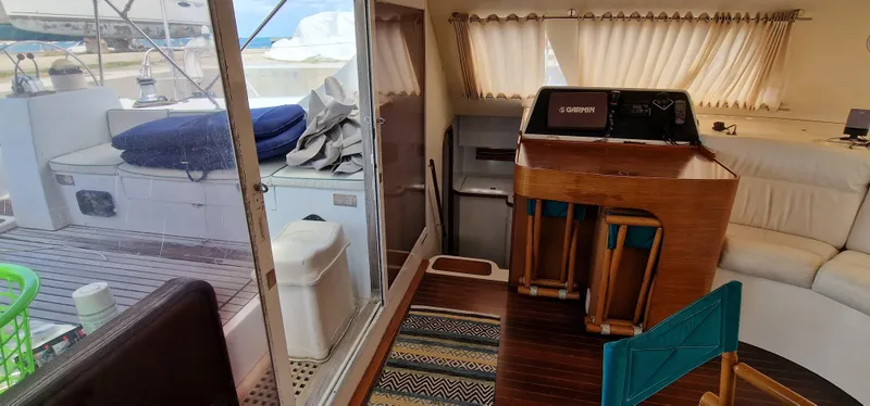 Lambada Yacht Photos Pics Interior of a 1993 Lagoon 47 yacht with wooden furnishings and nautical equipment.
