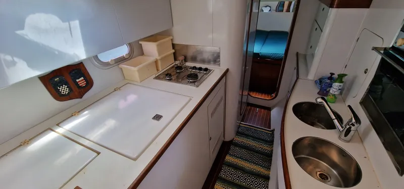 Lambada Yacht Photos Pics Interior of 1993 Lagoon 47 yacht kitchen with stove, sink, and storage.