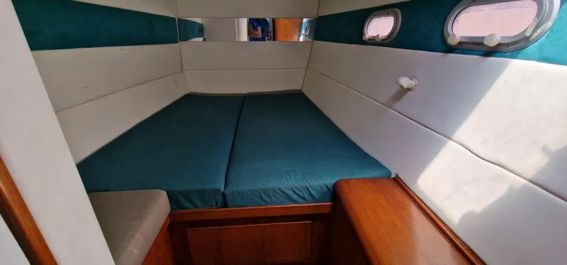 Lambada Yacht Photos Pics Cozy cabin interior of 1993 Lagoon 47 yacht with teal and white decor.