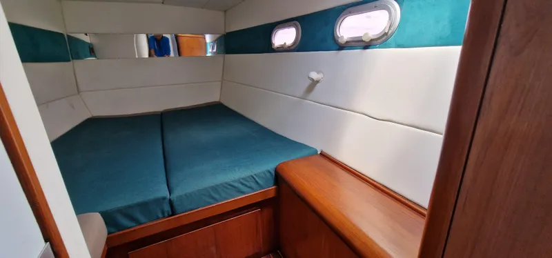 Lambada Yacht Photos Pics Cozy cabin interior of 1993 Lagoon 47 yacht with teal and white decor.