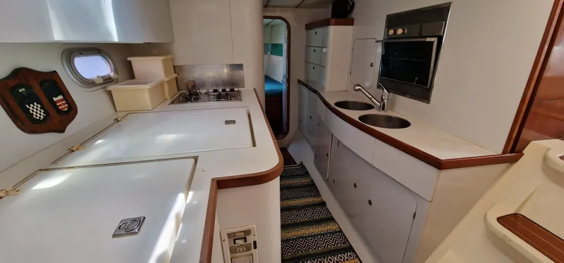 Lambada Yacht Photos Pics Interior of 1993 Lagoon 47 yacht kitchen with modern appliances and sleek design.