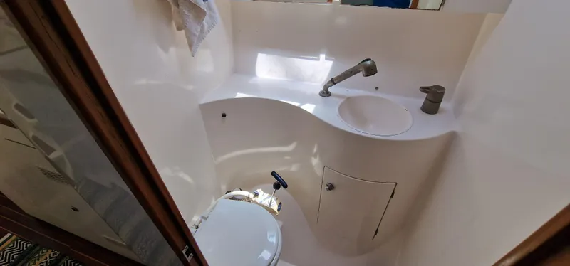 Lambada Yacht Photos Pics Bathroom interior of 1993 Lagoon 47 yacht, featuring sink and toilet.