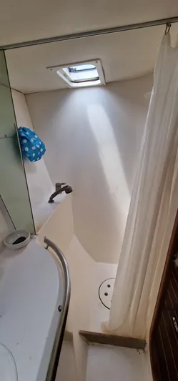 Lambada Yacht Photos Pics Bathroom interior of a 1993 Lagoon 47 yacht with shower and sink.