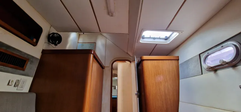 Lambada Yacht Photos Pics Interior of a 1993 Lagoon 47 yacht, featuring wooden cabinets and ceiling hatch.