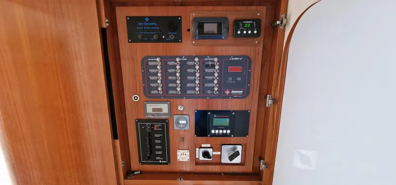 Lambada Yacht Photos Pics Control panel of a 1993 Lagoon 47 yacht with various switches and displays.