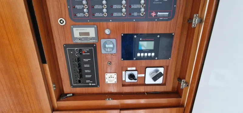 Lambada Yacht Photos Pics Control panel of a 1993 Lagoon 47 yacht with various switches and gauges.