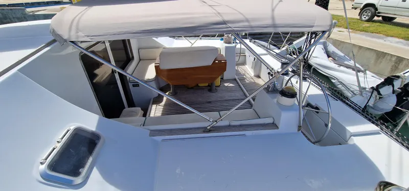 Lambada Yacht Photos Pics Lagoon 47 catamaran cockpit with seating, canopy, and steering wheel, 1993 model.