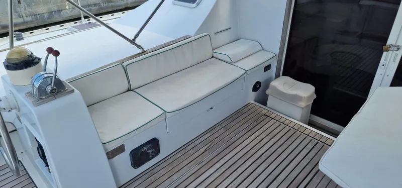 Lambada Yacht Photos Pics Cockpit of 1993 Lagoon 47 yacht with seating and wooden flooring.